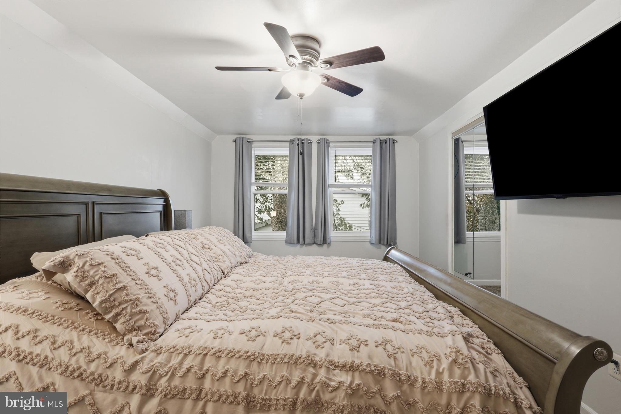 112 North Kennedy Road Sterling, VA 20164 - Photo 18 of 39 a bedroom with a large bed and a flat screen tv