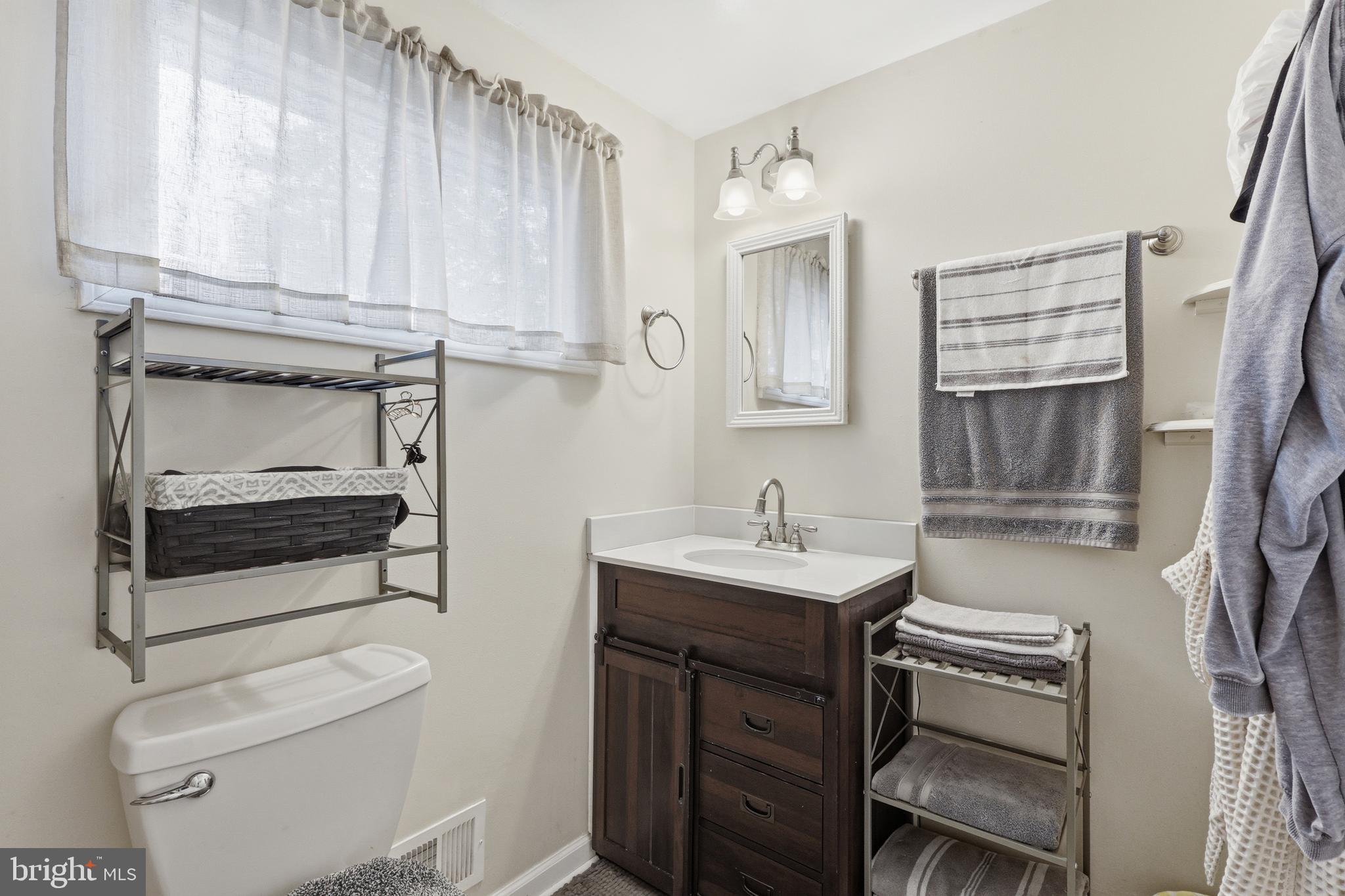 112 North Kennedy Road Sterling, VA 20164 - Photo 24 of 39 a bathroom with a sink a toilet and vanity