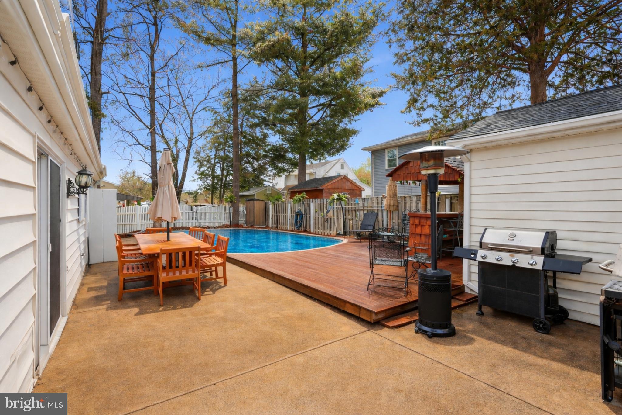 112 North Kennedy Road Sterling, VA 20164 - Photo 28 of 39 a view of a patio with table and chairs and couches with wooden fence and floor