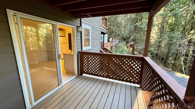 a view of a balcony with wooden floor
