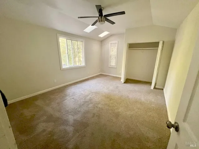 an empty room with windows and entrance