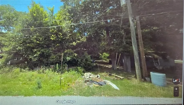 a backyard of a house with a yard and outdoor seating