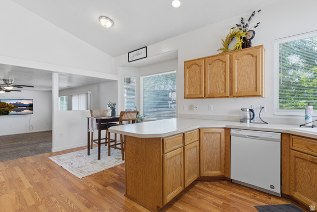 134 West 475 South Ogden, UT 84404 - Photo 7 of 27 Kitchen with light countertops, a peninsula, vaulted ceiling, white dishwasher, and healthy amount of natural light
