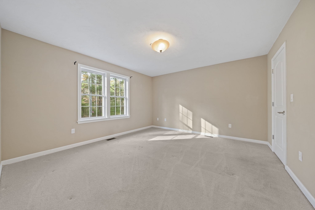 14 Red Pony Path, Unit 14 Marshfield, MA 02050 - Photo 16 of 40 an empty room with a window and a ceiling fan
