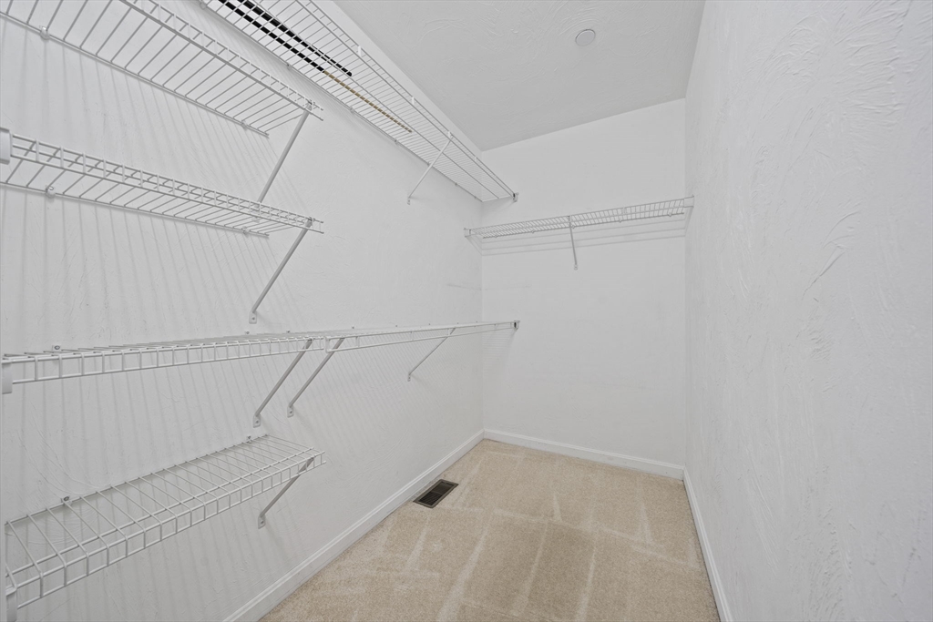 14 Red Pony Path, Unit 14 Marshfield, MA 02050 - Photo 20 of 40 a view of a room with racks on the wall