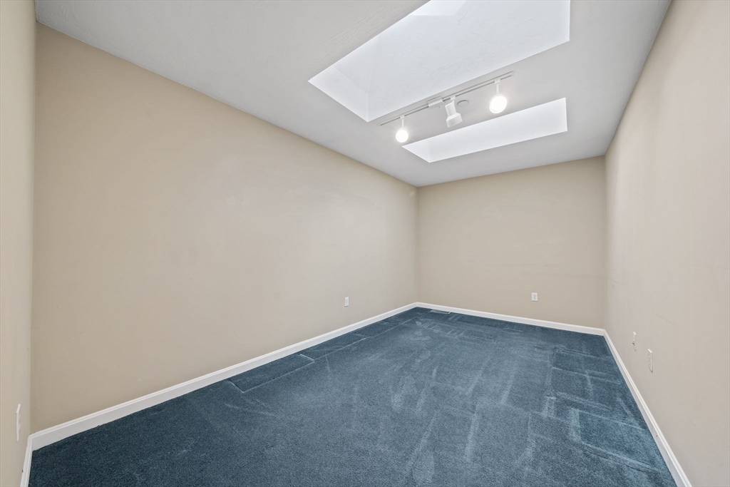 14 Red Pony Path, Unit 14 Marshfield, MA 02050 - Photo 25 of 40 an empty room with a workbench