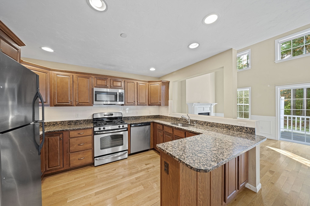 14 Red Pony Path, Unit 14 Marshfield, MA 02050 - Photo 4 of 40 a kitchen with stainless steel appliances granite countertop a sink stove and refrigerator