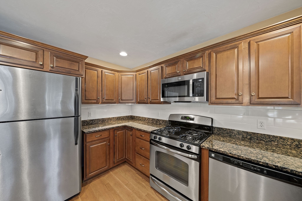 14 Red Pony Path, Unit 14 Marshfield, MA 02050 - Photo 7 of 40 a kitchen with stainless steel appliances granite countertop a refrigerator stove top oven and sink