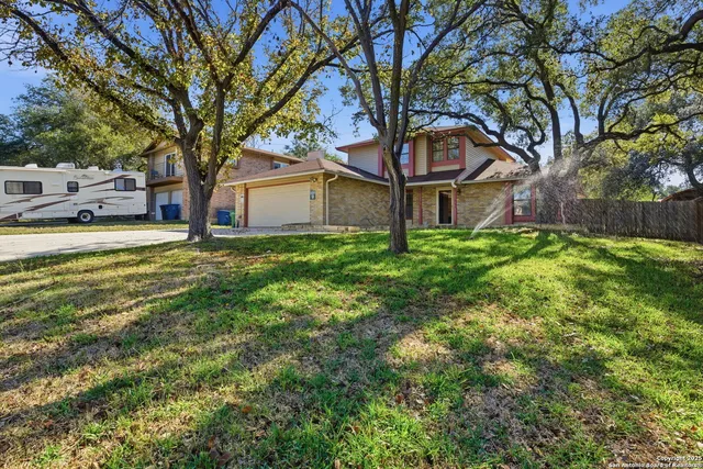 a house that has a tree in front of it