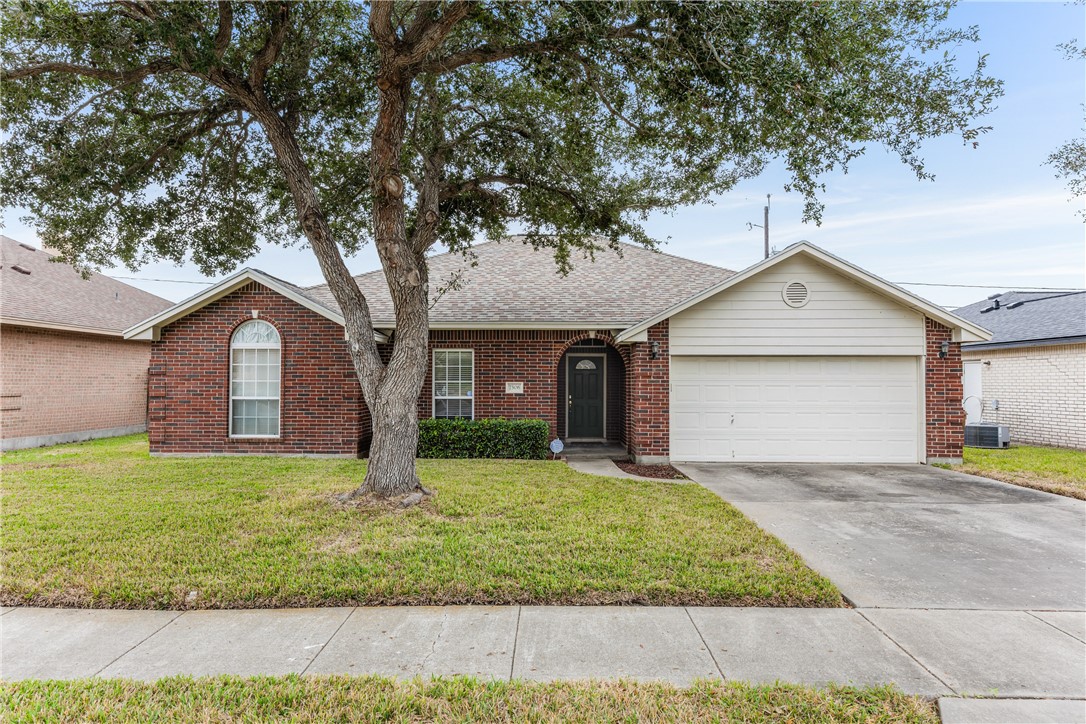a front view of a house with yard and garage
