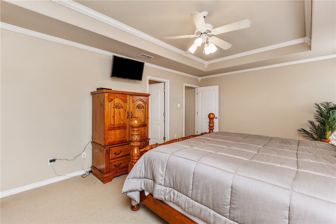 7306 Sun Valley Drive Corpus Christi, TX 78413 - Photo 20 of 40 a bedroom with a bed and a chandelier
