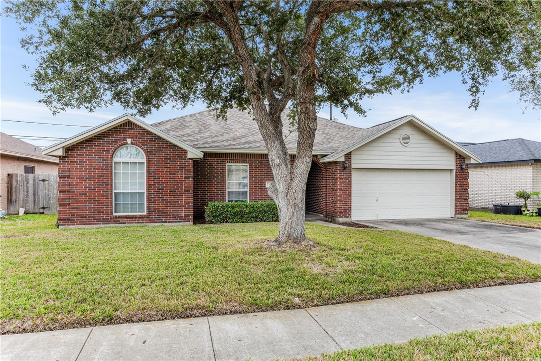 7306 Sun Valley Drive Corpus Christi, TX 78413 - Photo 2 of 40 a front view of a house with a yard and garage