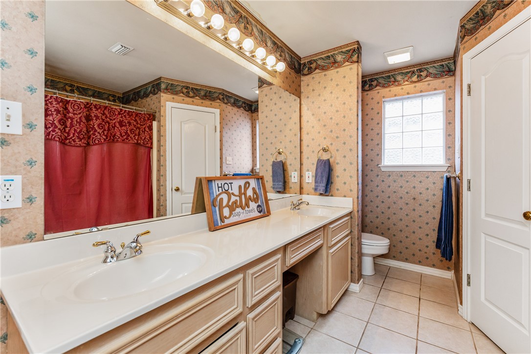 7306 Sun Valley Drive Corpus Christi, TX 78413 - Photo 22 of 40 a bathroom with a sink a toilet a mirror and shower
