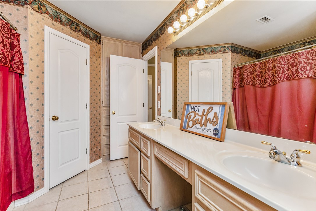 7306 Sun Valley Drive Corpus Christi, TX 78413 - Photo 23 of 40 a bathroom with a sink a mirror and a shower