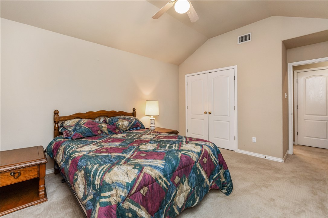 7306 Sun Valley Drive Corpus Christi, TX 78413 - Photo 29 of 40 a bedroom with a bed and a chandelier