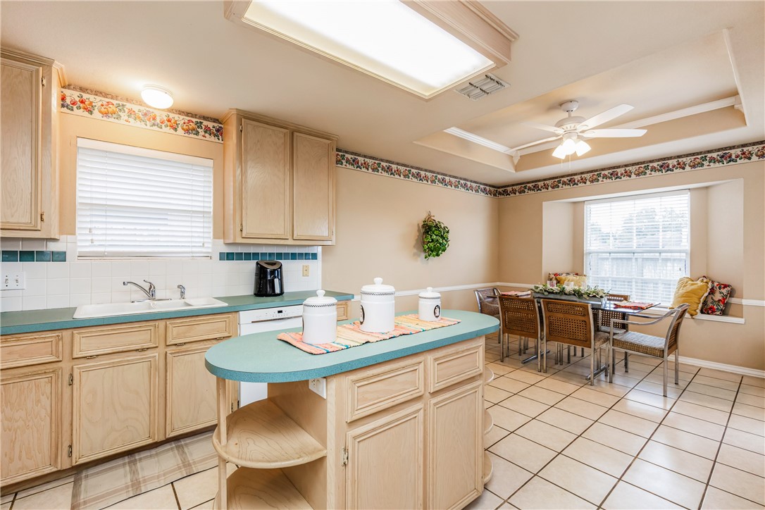 7306 Sun Valley Drive Corpus Christi, TX 78413 - Photo 10 of 40 a kitchen with a dining table chairs and white cabinets