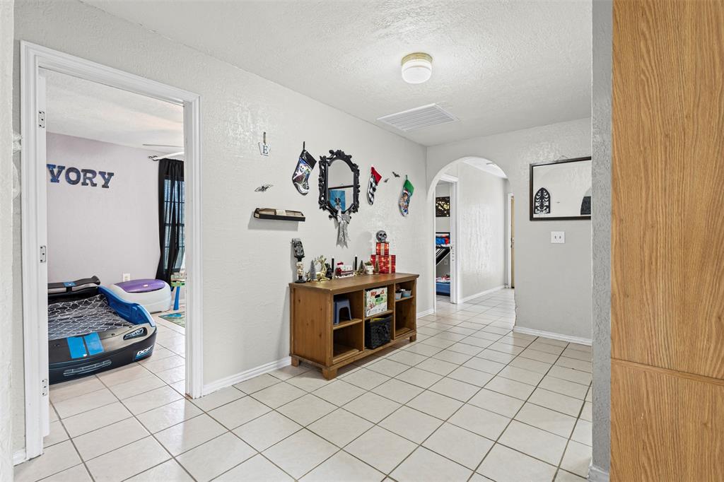2002 Northeast Main Street Ennis, TX 75119 - Photo 13 of 30 a view of a hallway with workspace and a window
