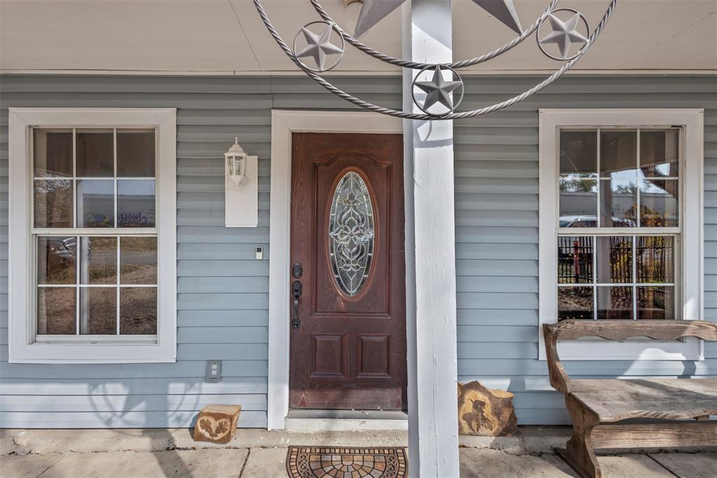 2002 Northeast Main Street Ennis, TX 75119 - Photo 5 of 30 a front view of a house with a glass door