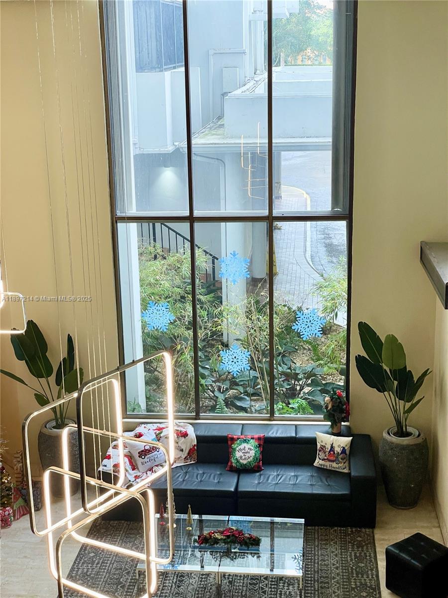 2750 Northeast 183rd Street, Unit 2308 Aventura, FL 33160 - Photo 15 of 19 a living room with furniture and a floor to ceiling window