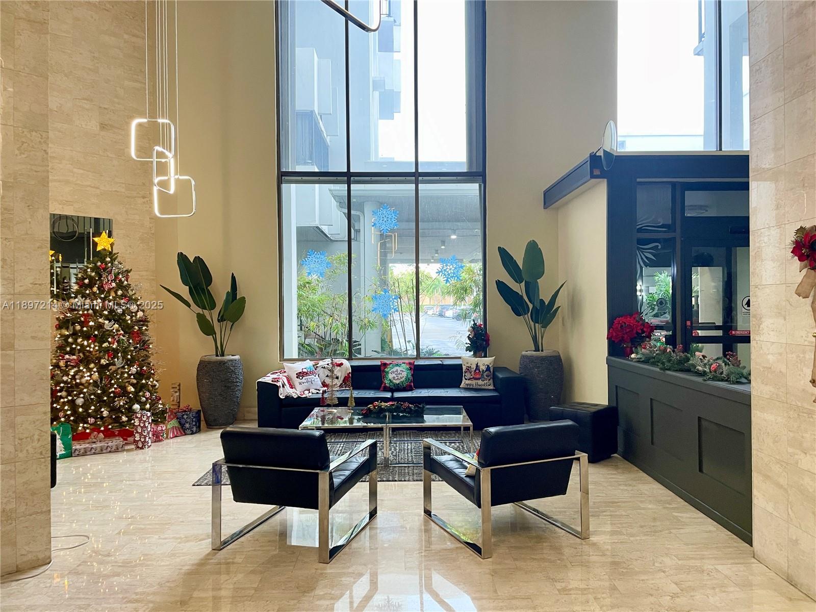 2750 Northeast 183rd Street, Unit 2308 Aventura, FL 33160 - Photo 19 of 19 a living room with furniture and a large window