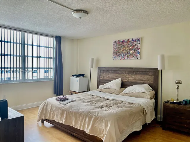 a bedroom with a bed and a desk