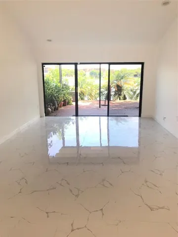 an empty room with large windows