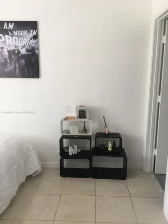 a bedroom with a bed and a wall painting