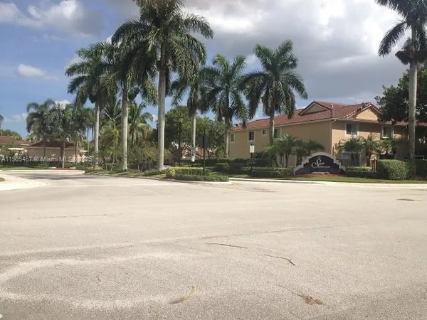 a view of road with palm trees