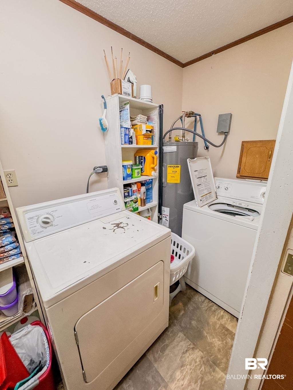 1456 Allen Walker Road Grove Hill, AL 36451 - Photo 28 of 28 Washroom featuring ornamental molding, a textured ceiling, water heater, and separate washer and dryer