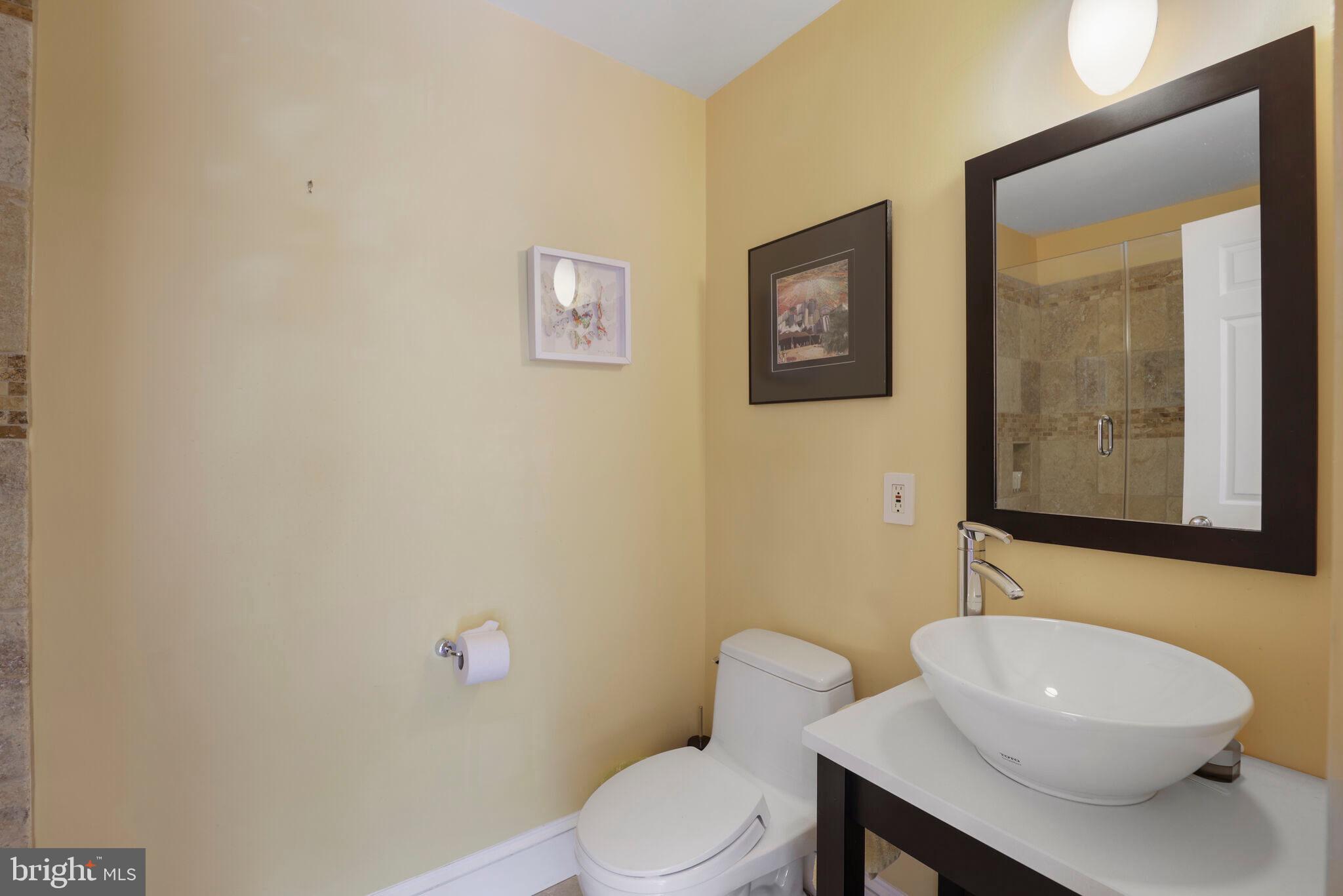 3927 Georgetown Court Northwest Washington, DC 20007 - Photo 26 of 34 a white toilet sitting next to a bathroom sink