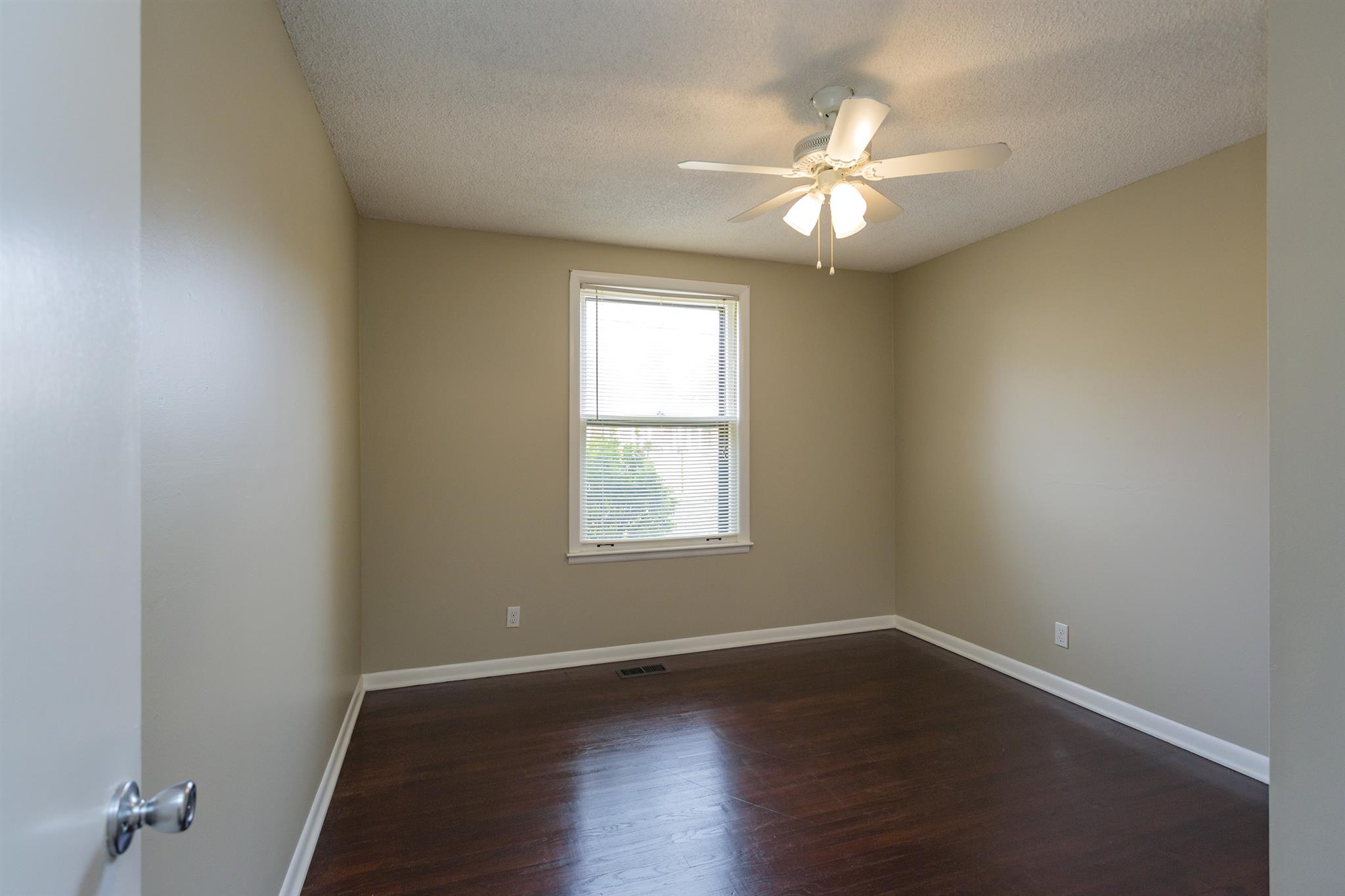 505 Harding Place Nashville, TN 37211 - Photo 13 of 24 an empty room with wooden floor and windows