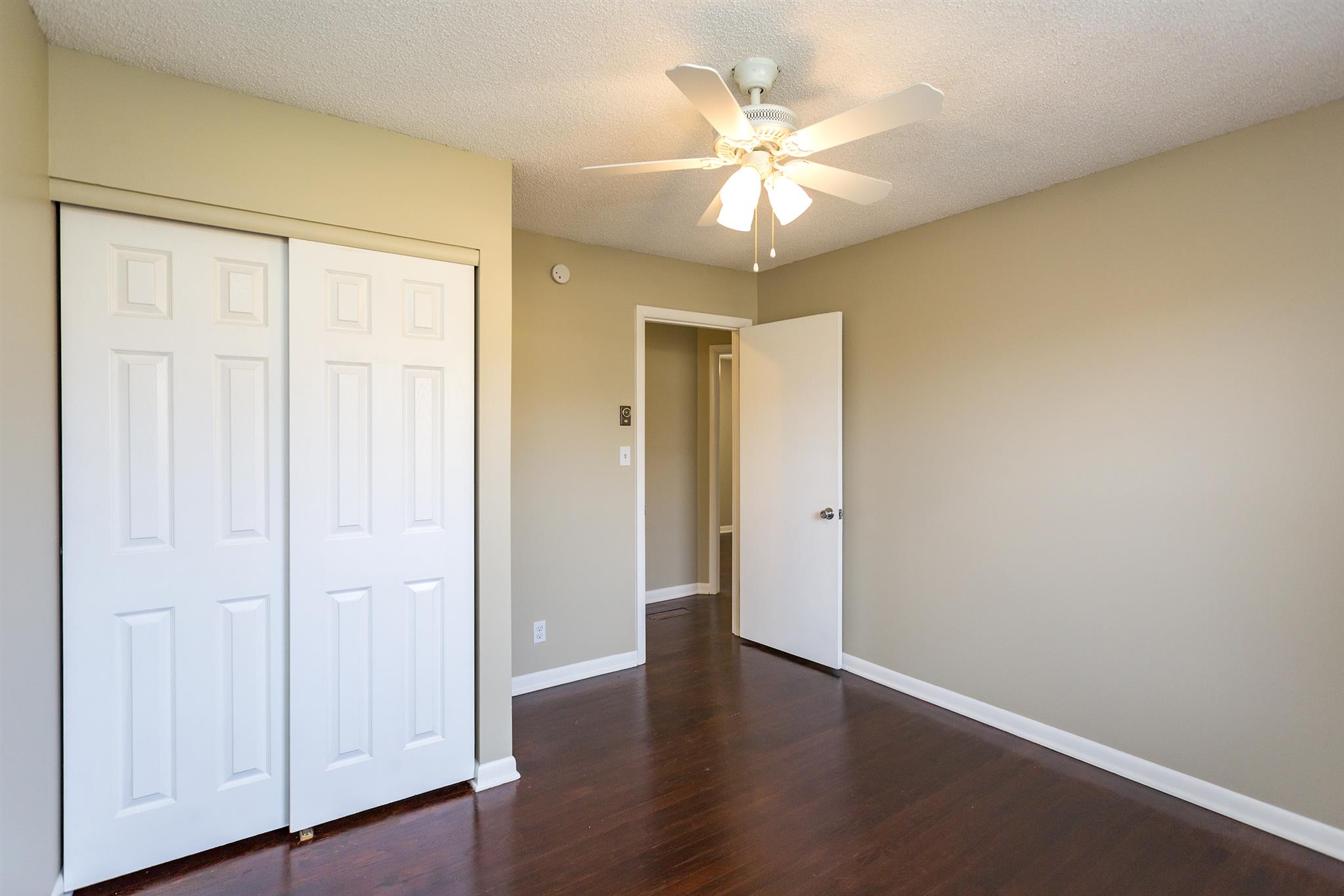 505 Harding Place Nashville, TN 37211 - Photo 14 of 24 an empty room with wooden floor and ceiling fan