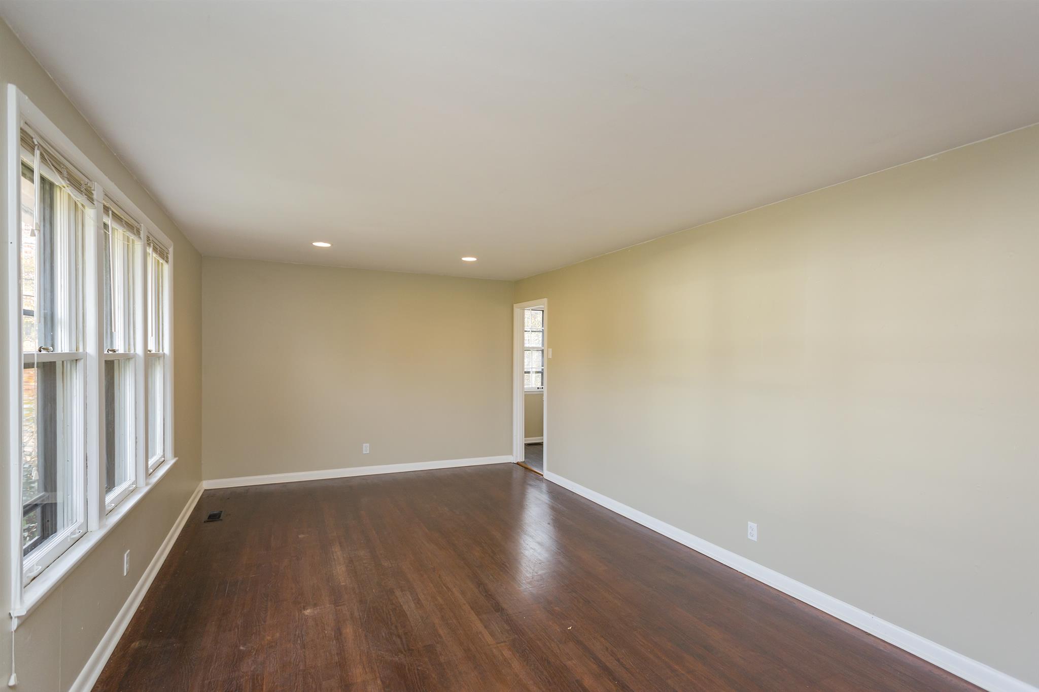 505 Harding Place Nashville, TN 37211 - Photo 4 of 24 a view of an empty room with wooden floor and a window