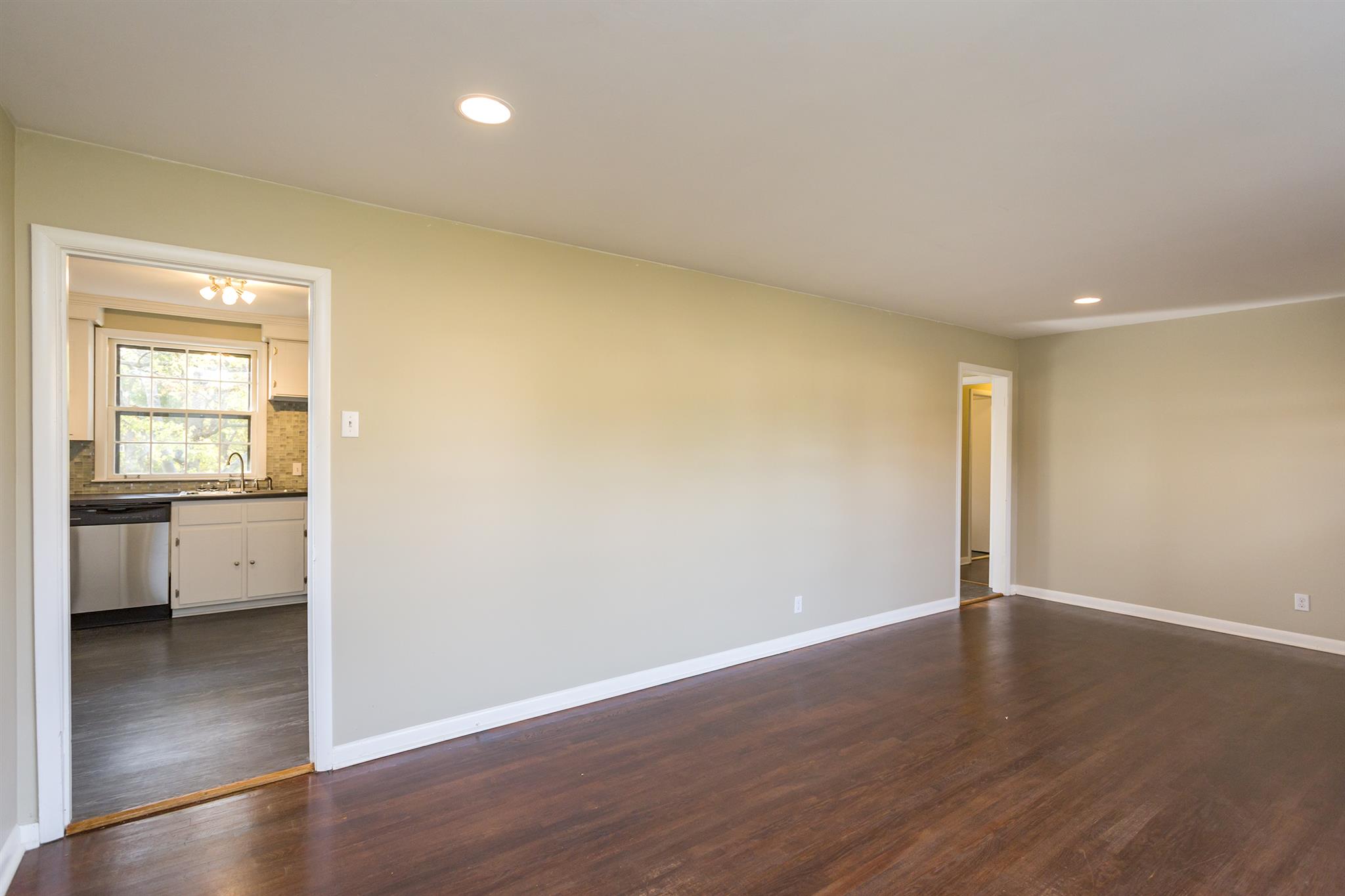 505 Harding Place Nashville, TN 37211 - Photo 5 of 24 a view of a room with wooden floor and a kitchen