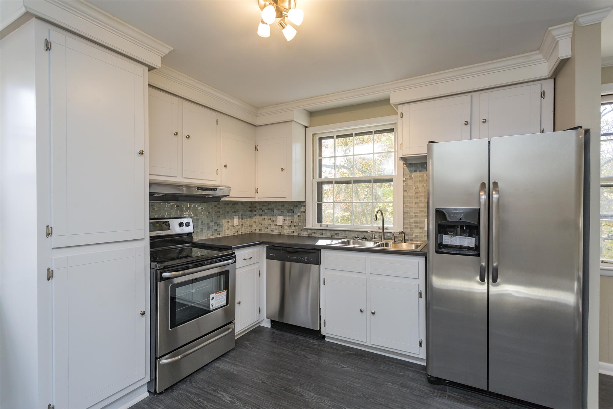 505 Harding Place Nashville, TN 37211 - Photo 7 of 24 a kitchen with granite countertop a refrigerator stove and sink
