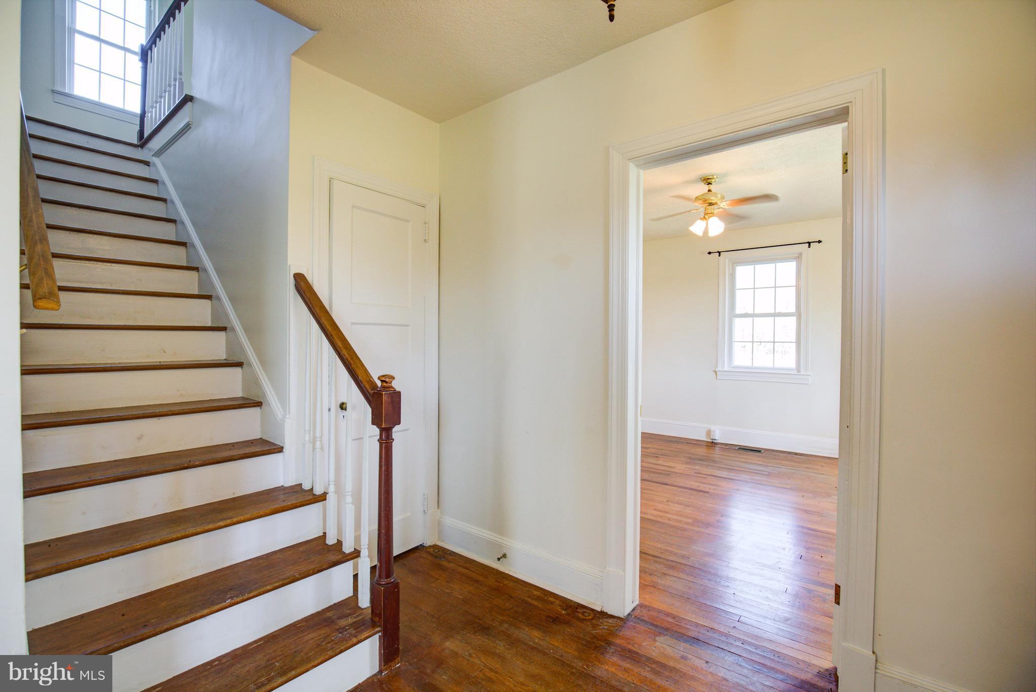 155 Summerville Road Boyce, VA 22620 - Photo 11 of 20 a view of a hallway with wooden floor and stairs