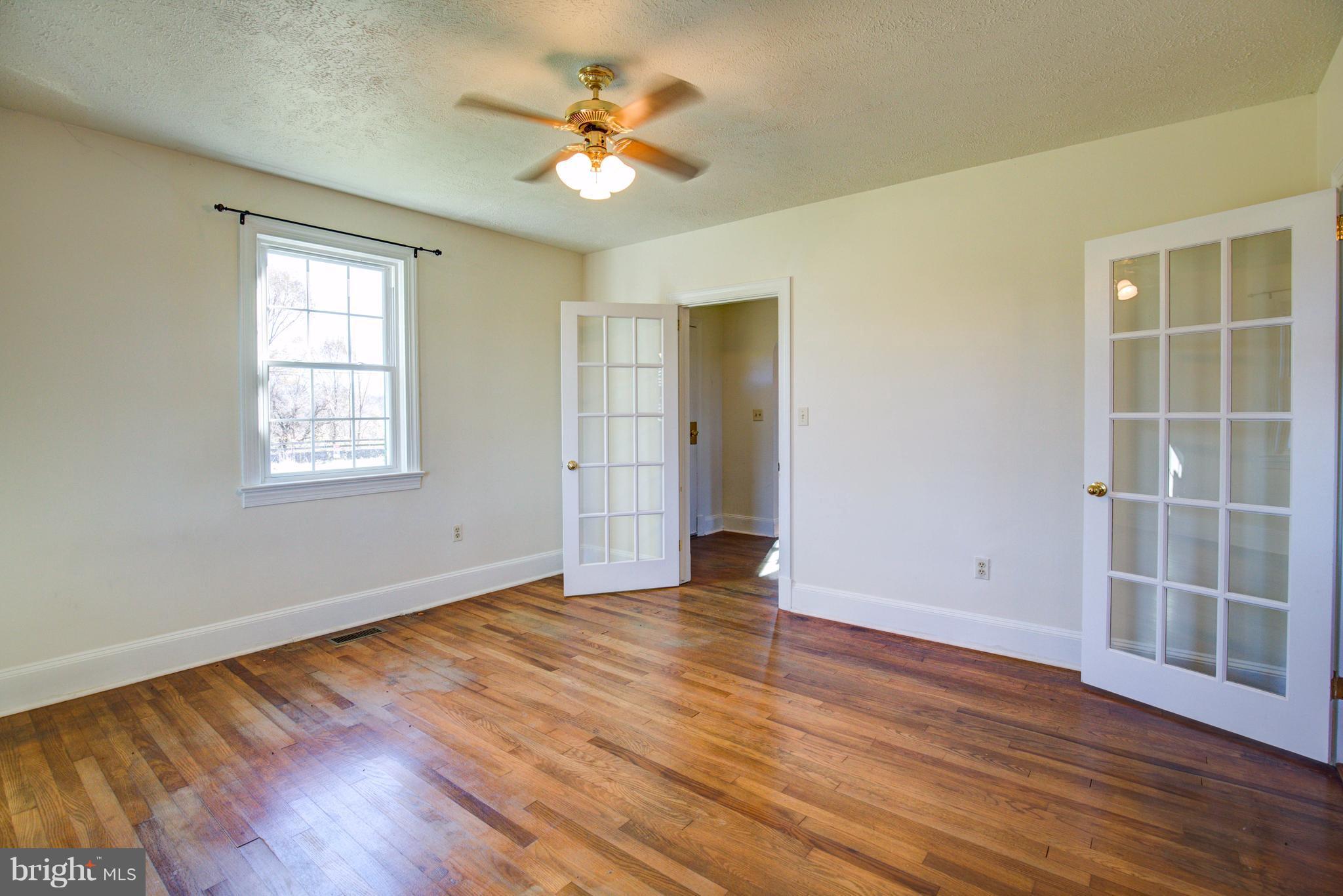 155 Summerville Road Boyce, VA 22620 - Photo 12 of 20 an empty room with wooden floor and window