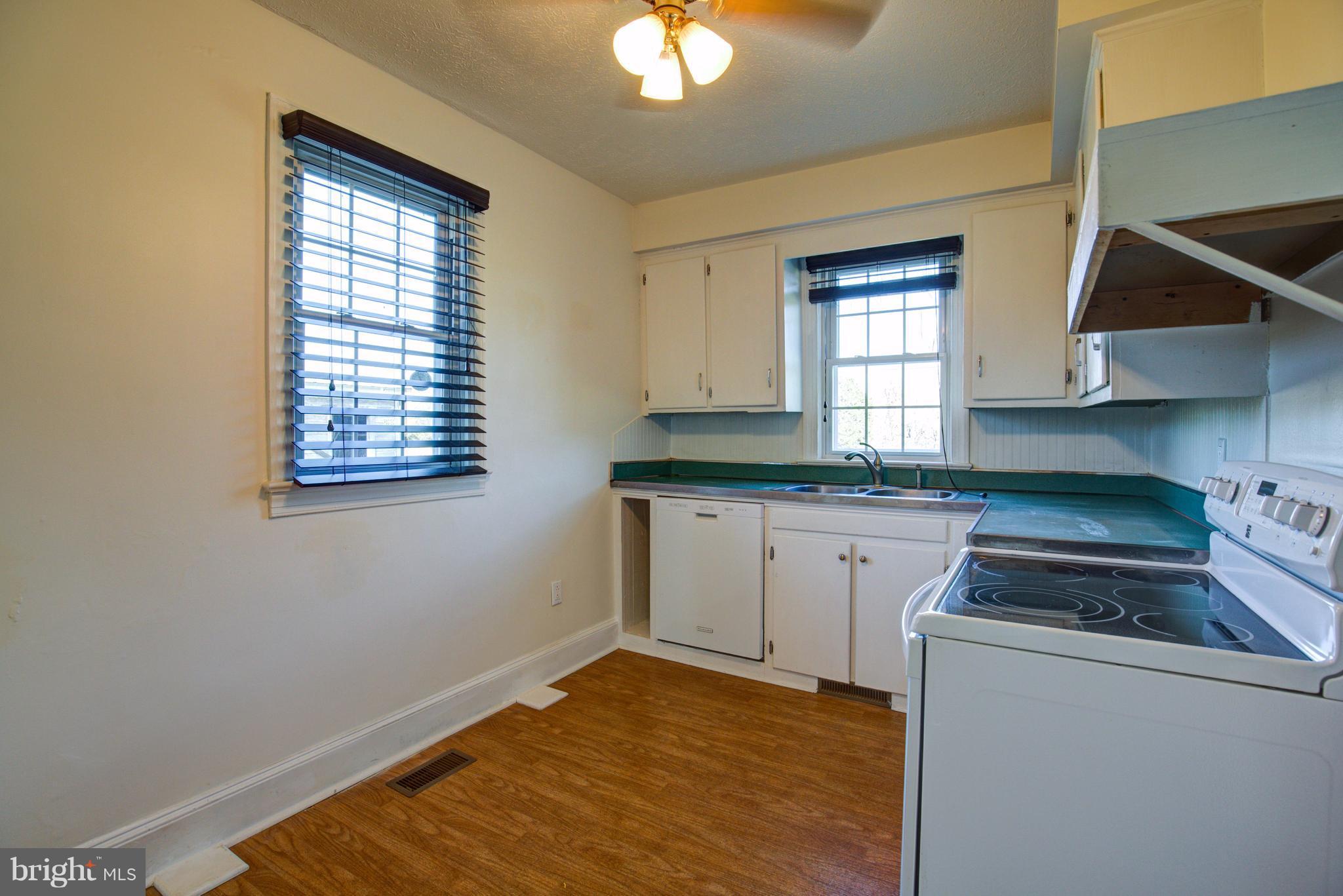 155 Summerville Road Boyce, VA 22620 - Photo 14 of 20 a kitchen with granite countertop white cabinets and window