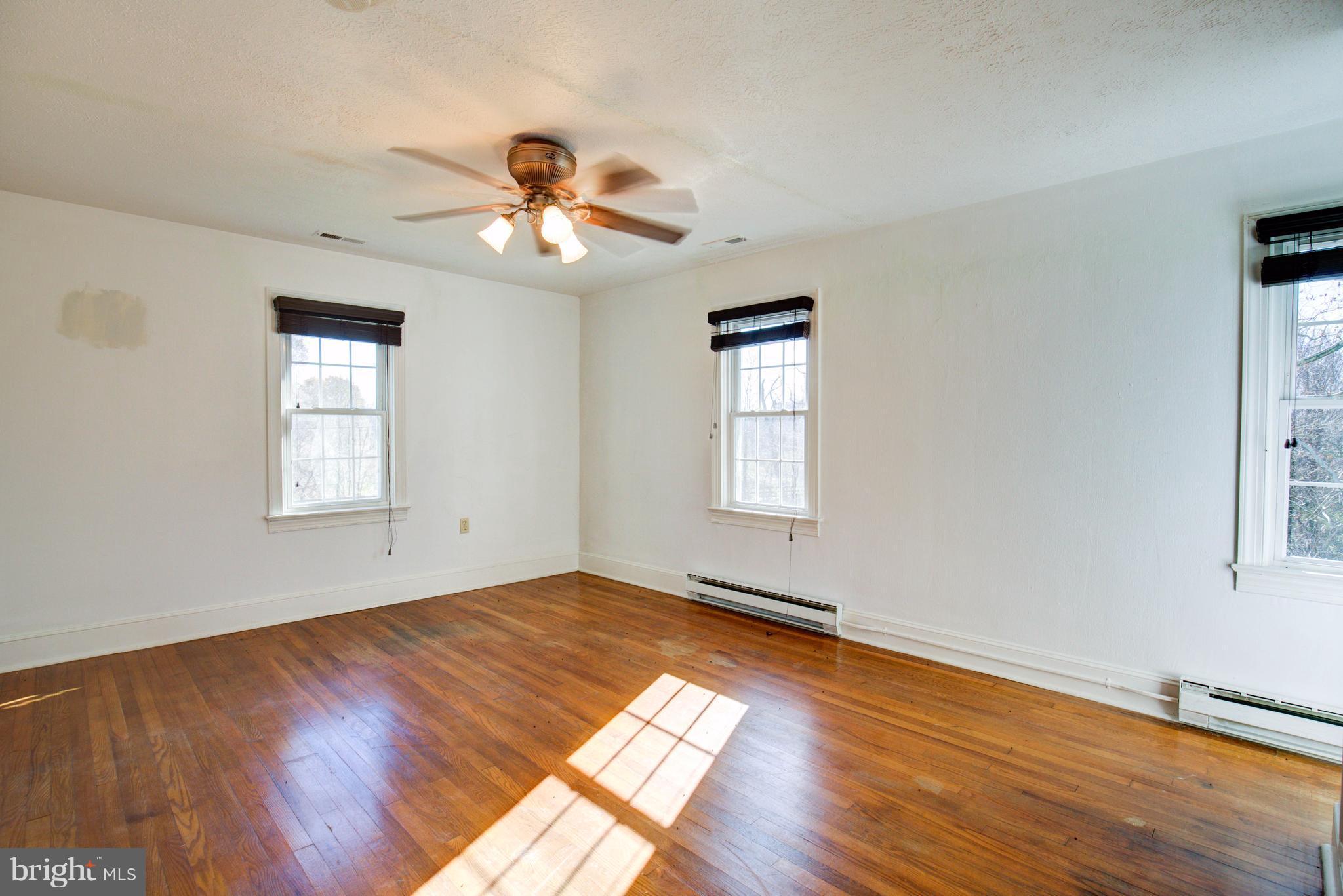 155 Summerville Road Boyce, VA 22620 - Photo 16 of 20 a view of an empty room with wooden floor and a window