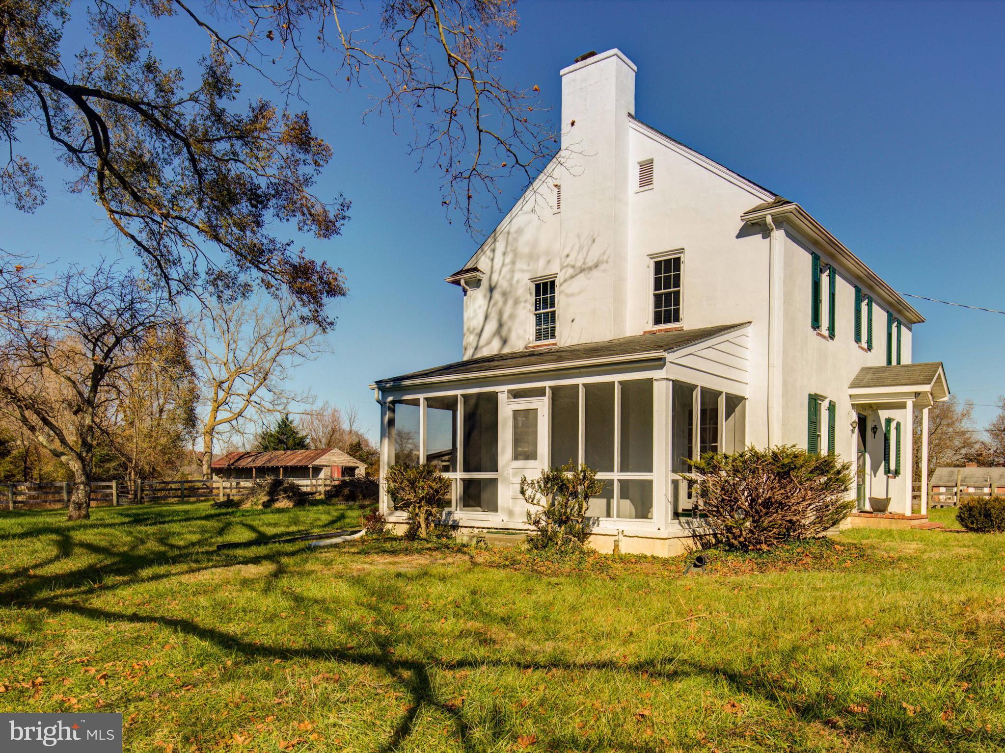 155 Summerville Road Boyce, VA 22620 - Photo 3 of 20 a view of a white house with large windows and a yard