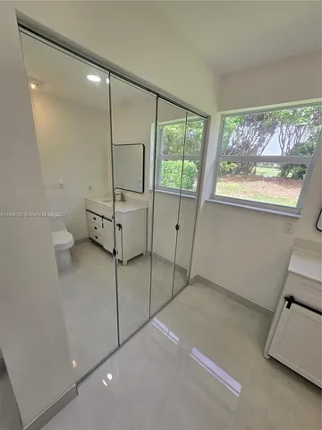 a room with a window and a projector screen