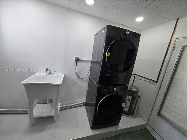 a kitchen with stainless steel appliances a sink a stove a refrigerator and cabinets