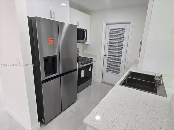 a kitchen that has a sink and a stove