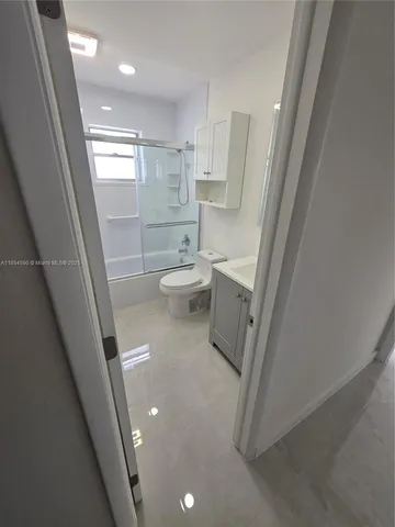 a white toilet sitting next to a bathroom sink