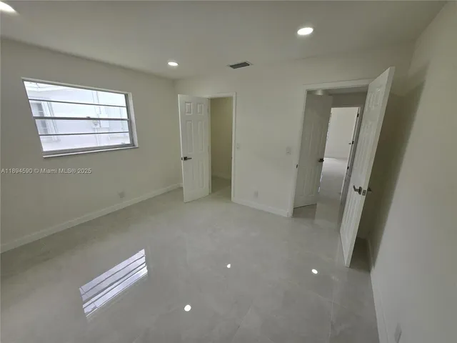 a bathroom with a shower and a sink