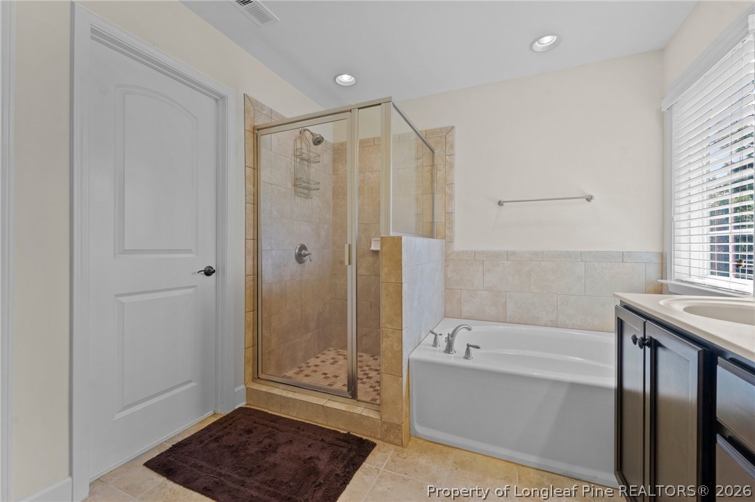 141 Pine Hawk Drive Spring Lake, NC 28390 - Photo 15 of 21 a bathroom with a bathtub and a shower