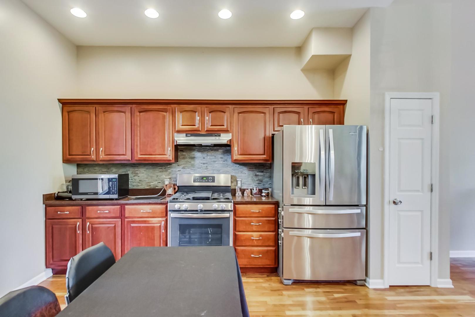 2101 Bull Ridge Drive McHenry, IL 60050 - Photo 15 of 83 a kitchen with stainless steel appliances granite countertop a refrigerator a stove a sink and a microwave