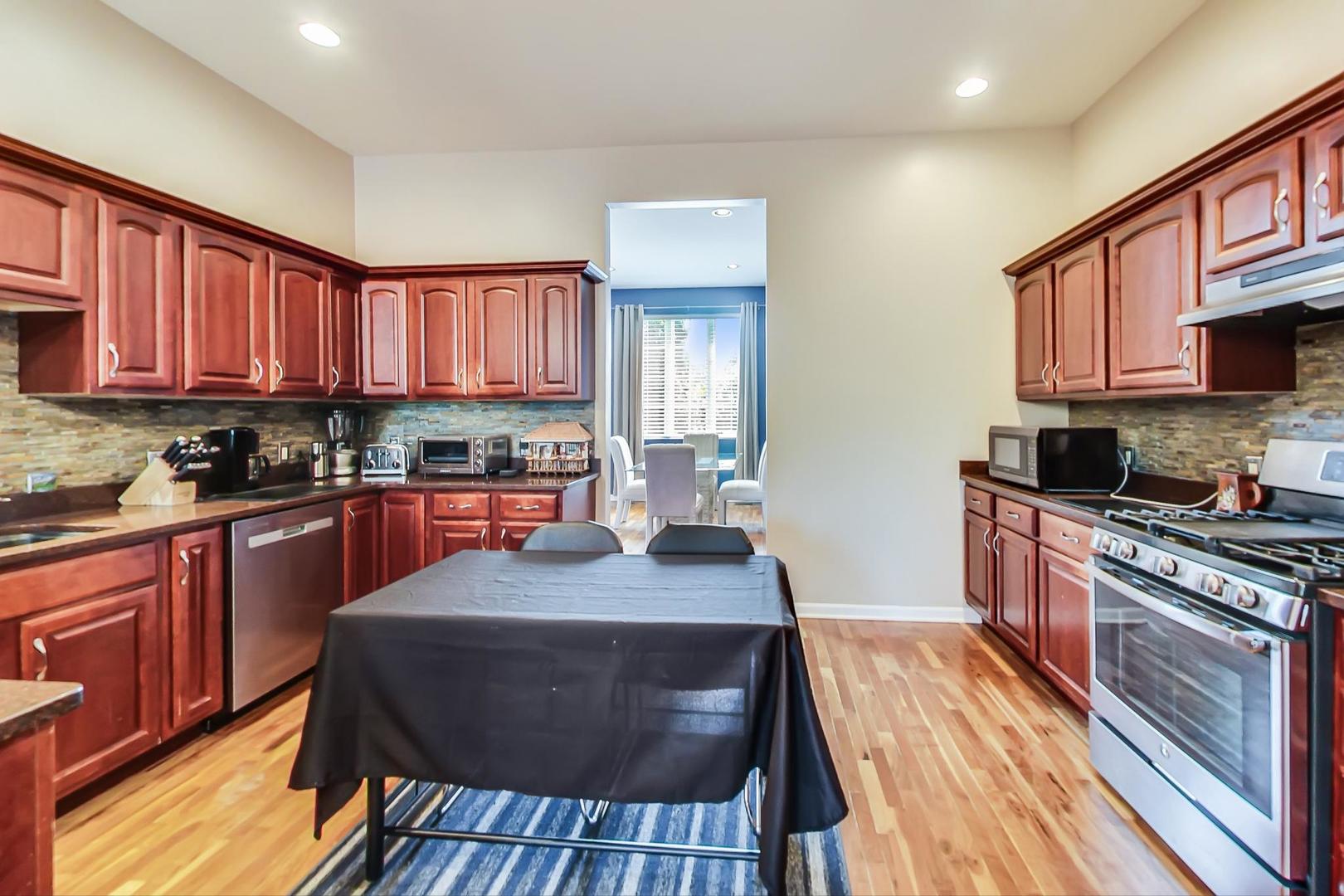 2101 Bull Ridge Drive McHenry, IL 60050 - Photo 16 of 83 a kitchen with granite countertop wooden cabinets a stove top oven a granite counter space and a window