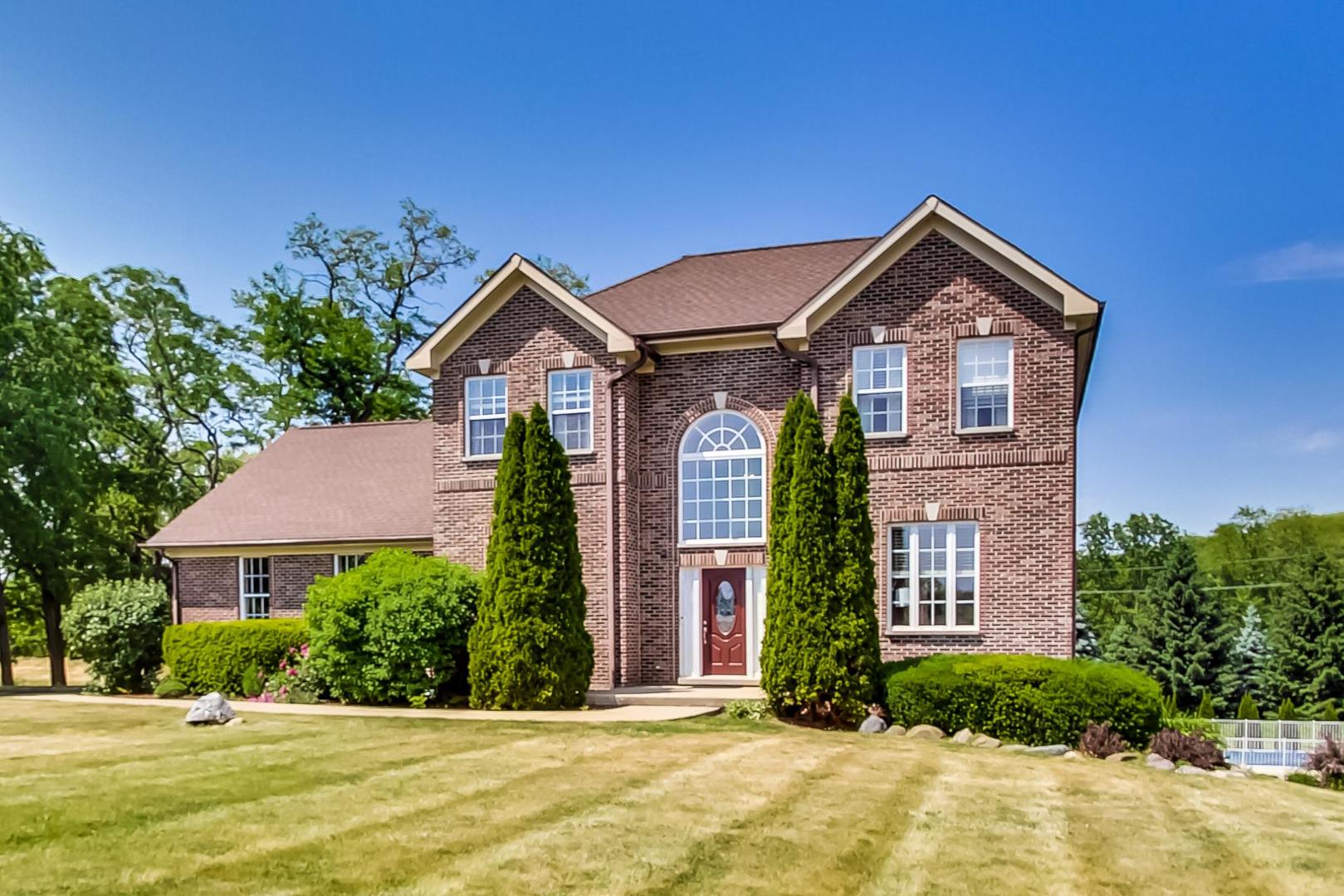 2101 Bull Ridge Drive McHenry, IL 60050 - Photo 2 of 83 a front view of a house with garden