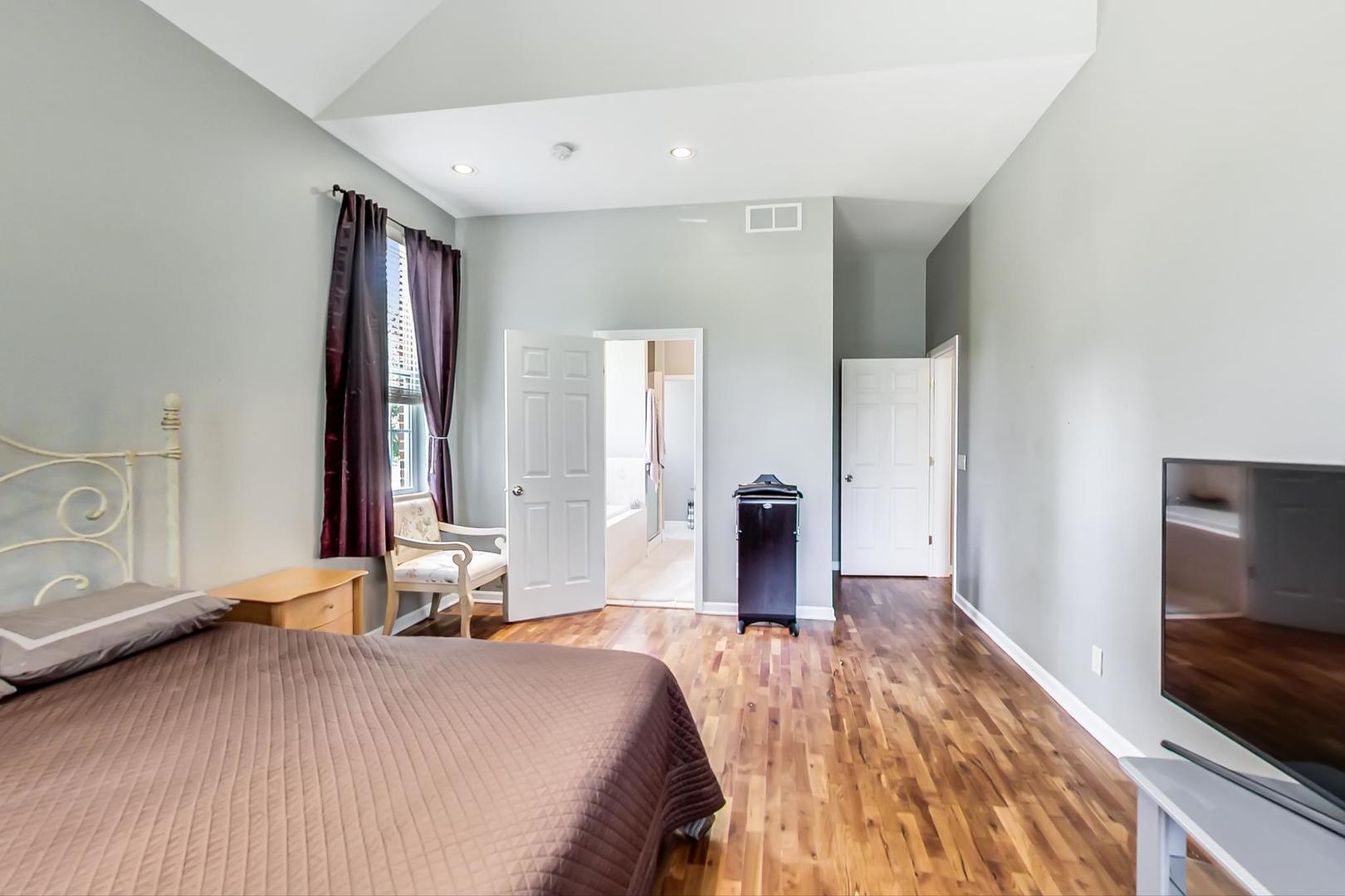 2101 Bull Ridge Drive McHenry, IL 60050 - Photo 25 of 83 a bedroom with a bed and a flat tv screen on wall
